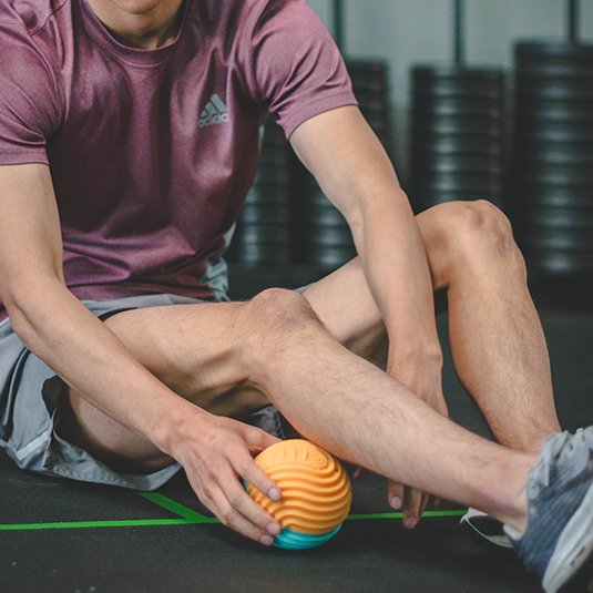 using vibrating massage ball on calf muscles